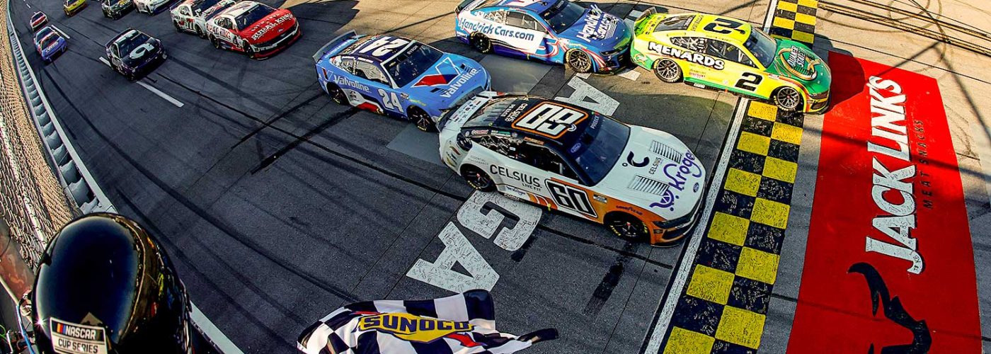 TALLADEGA, ALABAMA - APRIL 27: Austin Cindric, driver of the #2 Menards/Quaker State Ford, takes the checkered flag to win the NASCAR Cup Series Jack Link's 500 at Talladega Superspeedway on April 27, 2025 in Talladega, Alabama. (Photo by Logan Riely/Getty Images)