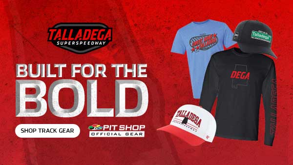 Talladega Superspeedway promotional graphic with the text “Built for the Bold,” featuring official track gear including T-shirts and hats, and a “Shop Track Gear” call-to-action alongside Pit Shop branding on a red textured background.